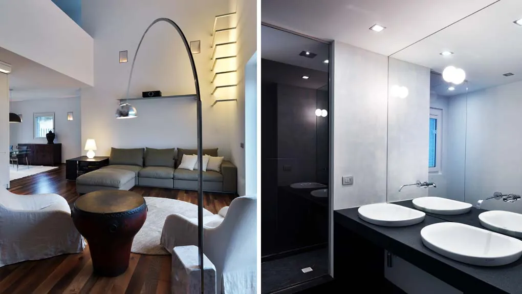Il soggiorno con la lampada ad arco e il bagno con i lavabi in pietra
